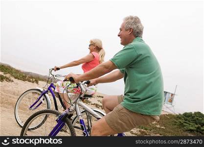 Middle-aged couple riding bicycles