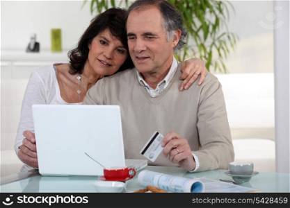 Middle-aged couple shopping on-line