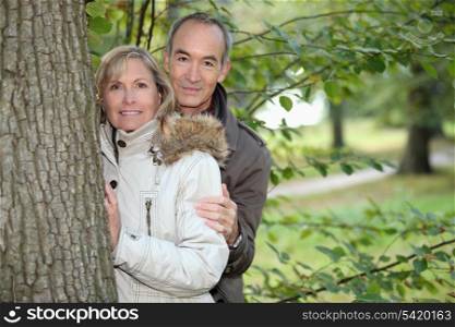 Middle-aged couple strolling in a public park