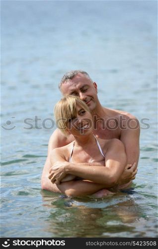 Middle-aged couple swimming