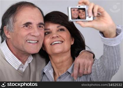 Middle aged couple taking a picture of themselves