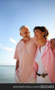 Middle-aged couple taking a stroll by the beach