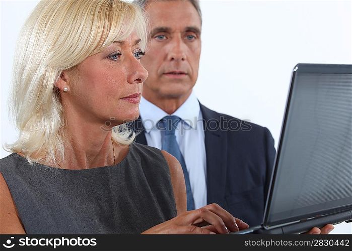 Middle-aged couple using laptop