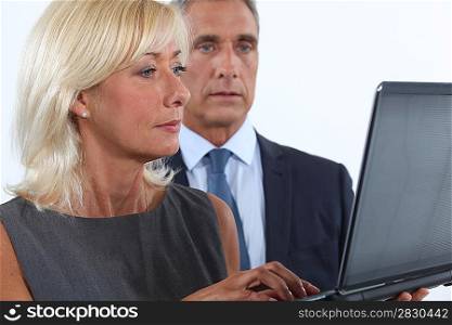 Middle-aged couple using laptop