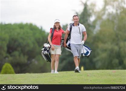 middle-aged couple walking on the golf course