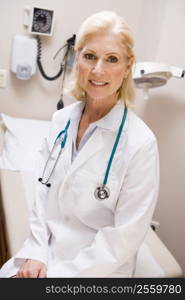 Middle Aged Female Doctor Sitting In A Hospital Ward