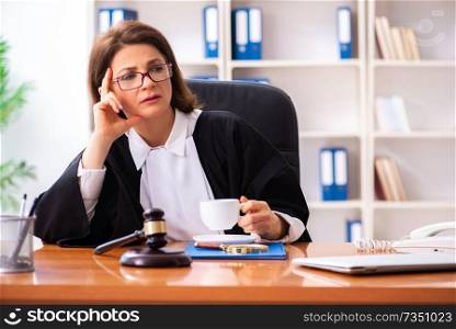 Middle-aged female doctor working in courthouse 