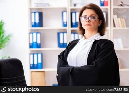 Middle-aged female doctor working in courthouse 