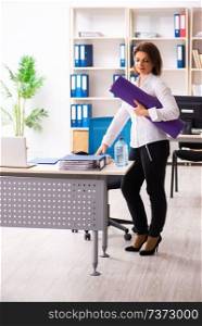 Middle-aged female employee doing exercises in the office 
