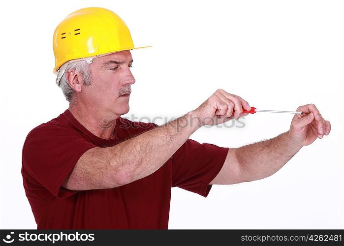 Middle-aged handyman using screw-driver