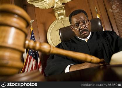 Middle-aged judge, gavel in front of him
