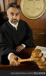 Middle-aged judge holding gavel