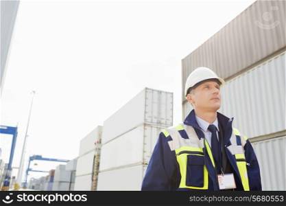Middle-aged male worker looking away in shipping yard