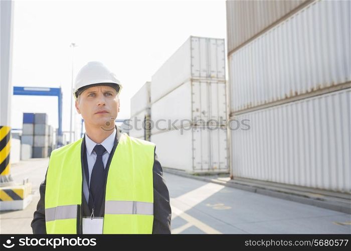 Middle-aged male worker looking away in shipping yard