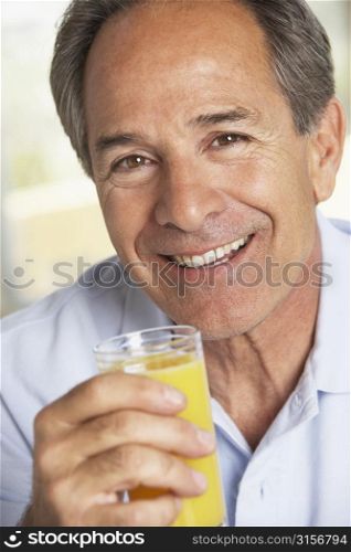 Middle Aged Man Drinking Fresh Orange Juice