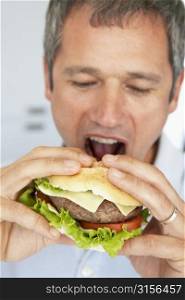 Middle Aged Man Eating A Burger