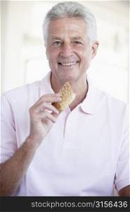 Middle Aged Man Eating Brown Bread Roll
