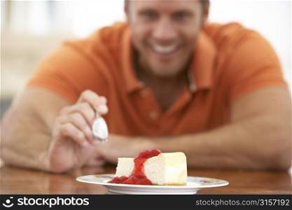 Middle Aged Man Eating Cheesecake