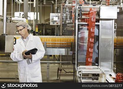 Middle-aged man having inspection at bottling industry