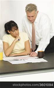 Middle Aged Man Helping Woman with Finances