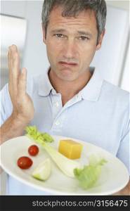 Middle Aged Man Holding A Plate Of Fresh And Healthy Food