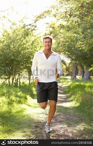 Middle Aged Man Jogging In Park