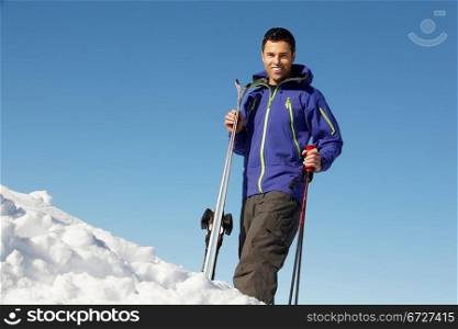 Middle Aged Man On Ski Holiday In Mountains