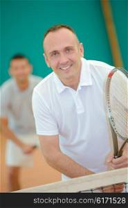 middle-aged man playing tennis
