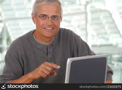 Middle Aged Man Pointing at Laptop