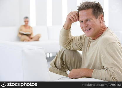 Middle-aged man relaxing on sofa