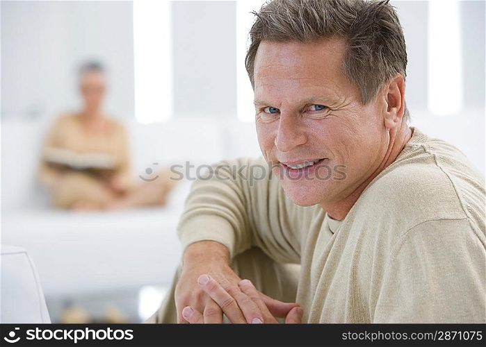 Middle-aged man relaxing on sofa
