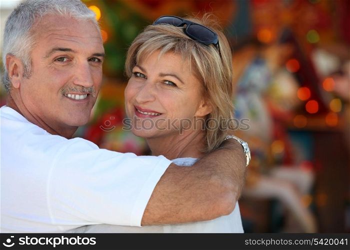 Middle aged man with his arm around his wife