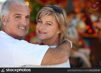 Middle aged man with his arm around his wife