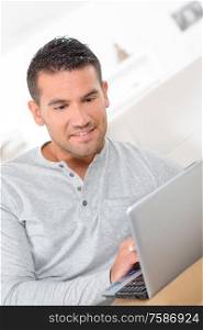 middle-aged man working from home on laptop computer