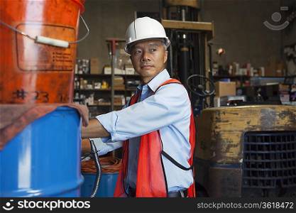 Middle-aged manager looking at something in warehouse