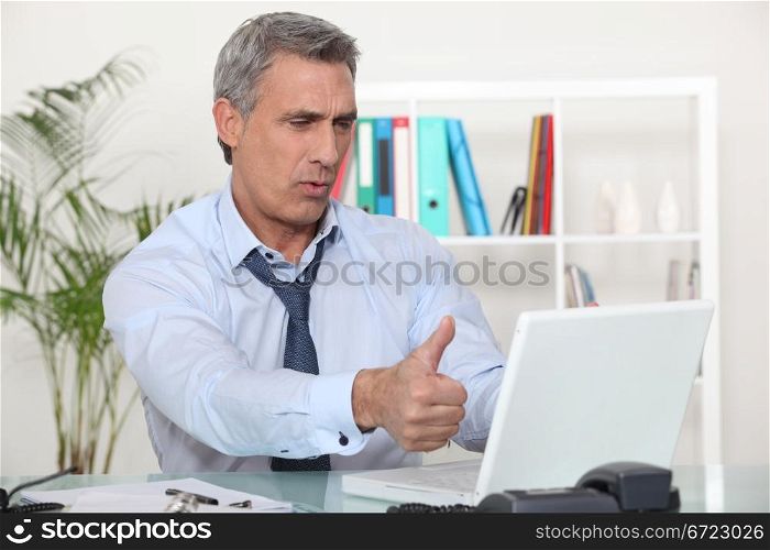 Middle-aged office worker giving thumbs-up
