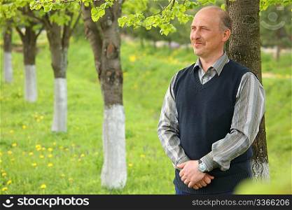 middle-aged smiling man in summer garden