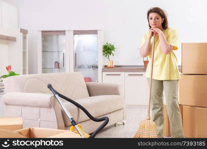 Middle-aged woman cleaning new apartment 