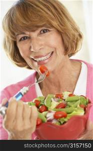 Middle Aged Woman Eating A Fresh Green Salad