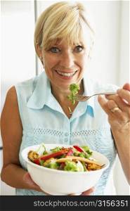 Middle Aged Woman Eating A Healthy Salad