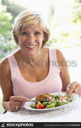 Middle Aged Woman Eating An Al Fresco Lunch