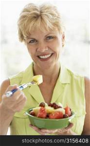 Middle Aged Woman Eating Fresh Fruit Salad