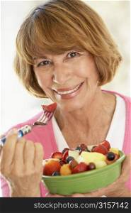 Middle Aged Woman Eating Fresh Fruit Salad