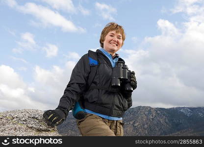 Middle-aged woman holding binoculars