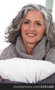 Middle-aged woman hugging pillow
