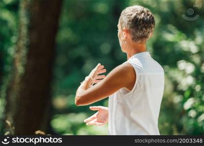 Middle Aged Woman Practicing Tai Chi Chuan in the Park. Close Up On Hands Position