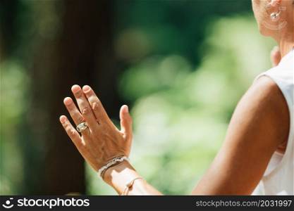 Middle Aged Woman Practicing Tai Chi Chuan in the Park. Close Up On Hands Position