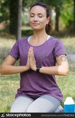 middle-aged woman practicing yoga with hands in prayer position