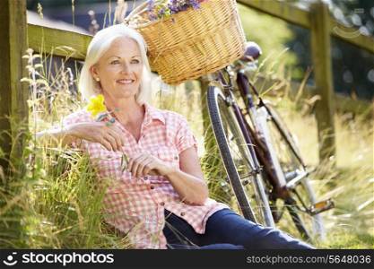 Middle Aged Woman Relaxing On Country Cycle Ride