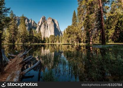Middle Cathedral Rock reflecting in Merced River at Yosemite National Park. California, USA.